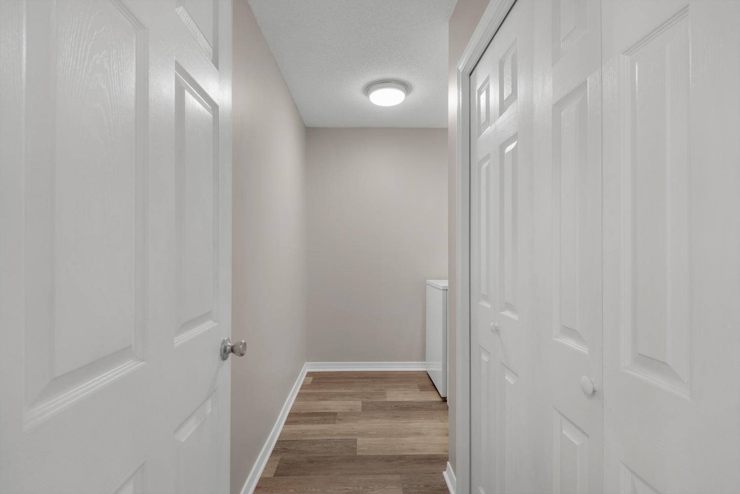 212 Tooke Street, Unit A Fort Walton Beach, FL 32547 - Photo 20 of 26 a view of a hallway with wooden floor and a bathroom