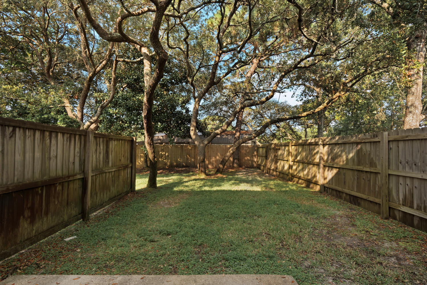 212 Tooke Street, Unit A Fort Walton Beach, FL 32547 - Photo 22 of 26 a backyard of a house with lots of green space