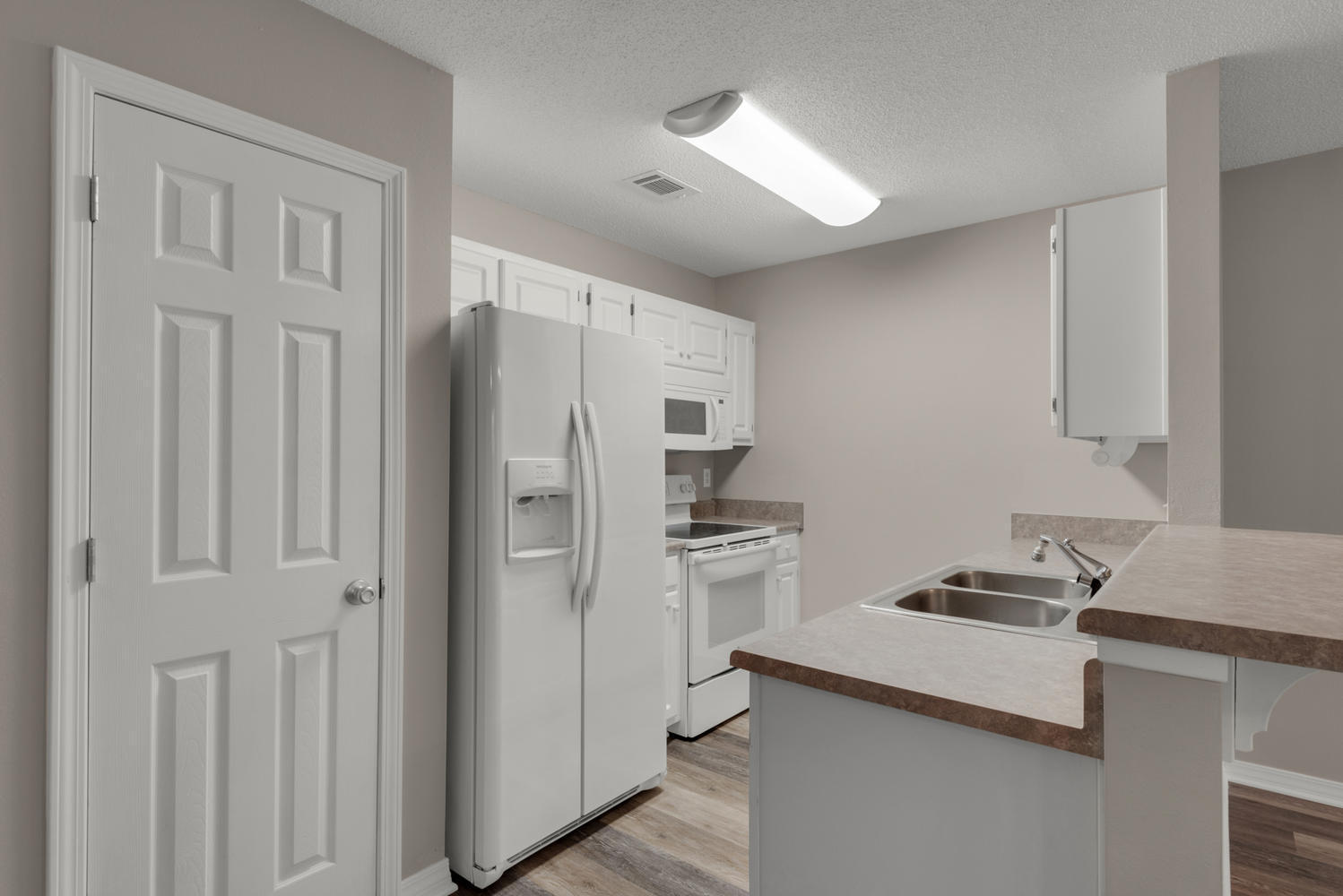 212 Tooke Street, Unit A Fort Walton Beach, FL 32547 - Photo 4 of 26 a kitchen with stainless steel appliances granite countertop a refrigerator and a stove