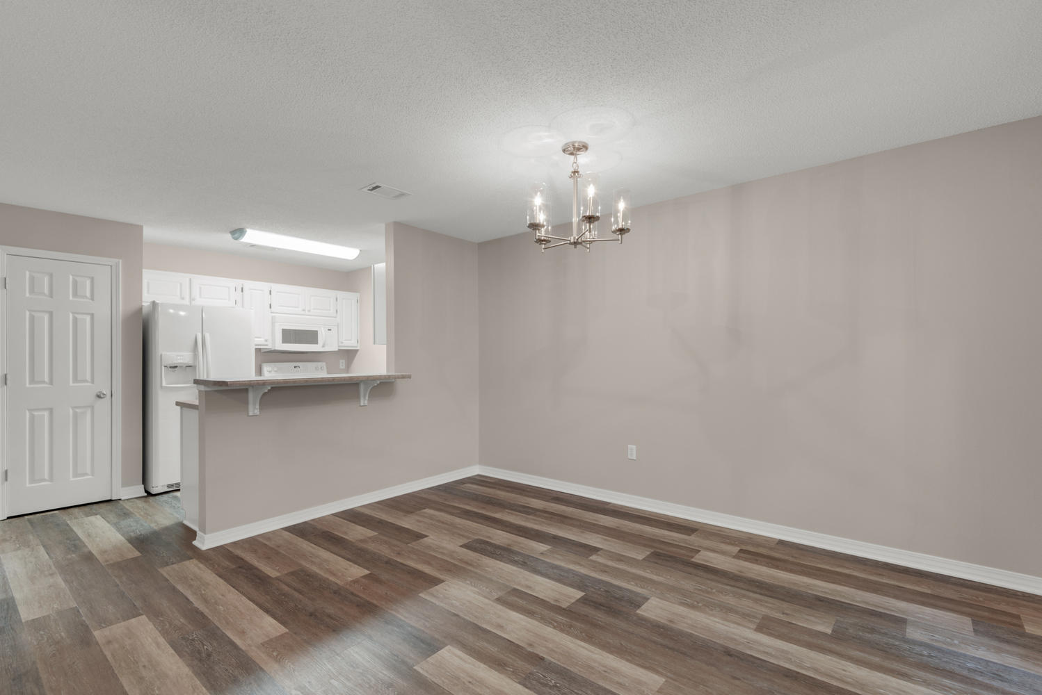 212 Tooke Street, Unit A Fort Walton Beach, FL 32547 - Photo 7 of 26 a view of empty room with kitchen view and wooden floor