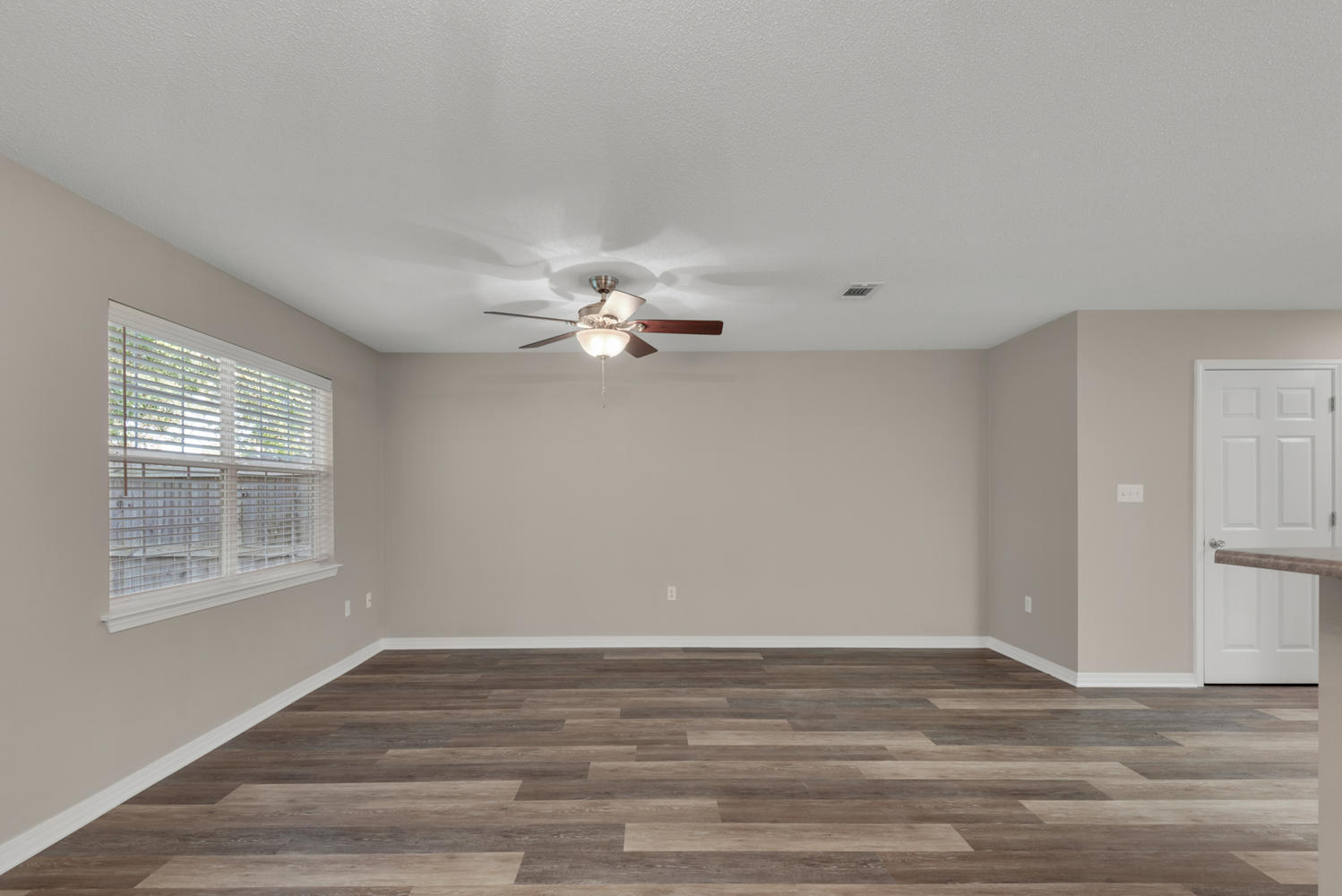 212 Tooke Street, Unit A Fort Walton Beach, FL 32547 - Photo 8 of 26 a view of empty room with wooden floor and fan