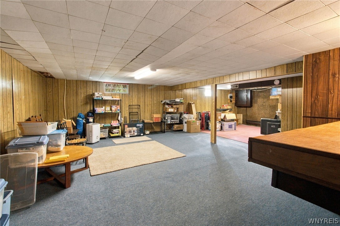 123 Ranch Trail West Amherst, NY 14221 - Photo 33 of 38 Retro wood paneling defines this expansive lower level recreation room with durable carpeting.