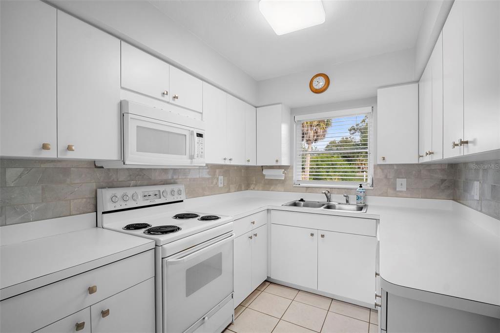 29098 Riverview Lane Punta Gorda, FL 33982 - Photo 12 of 35 a kitchen with cabinets appliances a sink and a window