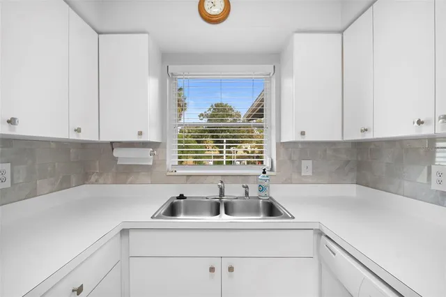a view of a kitchen with sink and cabinets