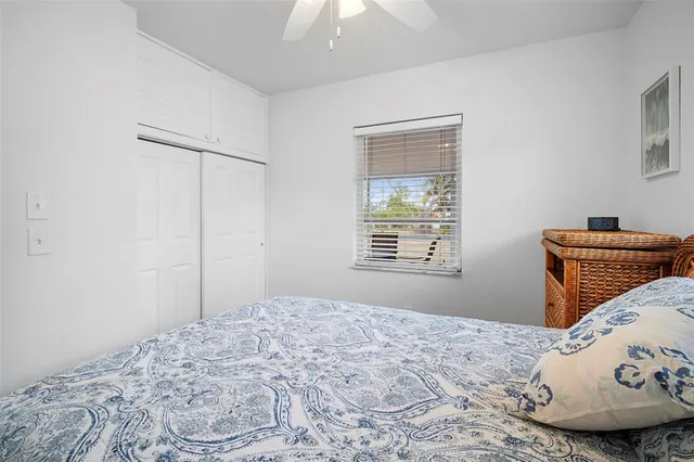 an empty room with windows and cabinet