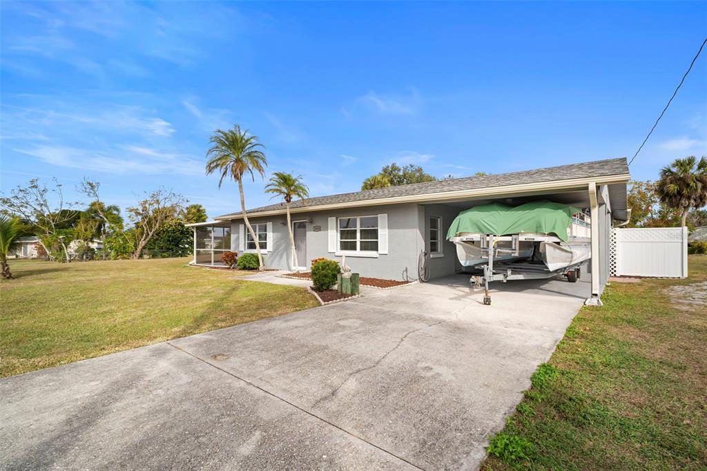 29098 Riverview Lane Punta Gorda, FL 33982 - Photo 2 of 35 a front view of house with outdoor seating and covered with trees