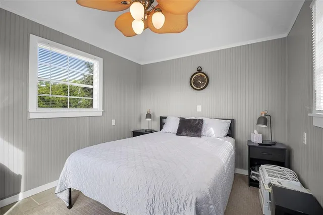 a bedroom with a bed and chandelier