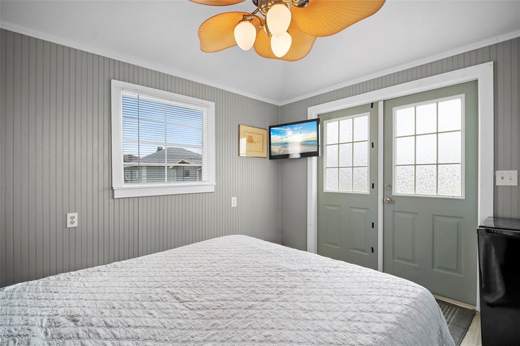 29098 Riverview Lane Punta Gorda, FL 33982 - Photo 24 of 35 a bedroom with a bed and chandelier