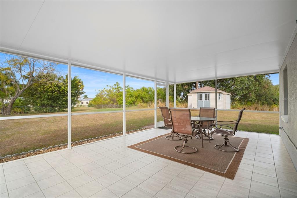 29098 Riverview Lane Punta Gorda, FL 33982 - Photo 27 of 35 a view of a patio with a table chairs and garden