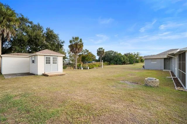 a backyard of a house with palm trees