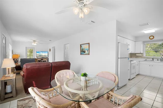 a living room with furniture and kitchen view