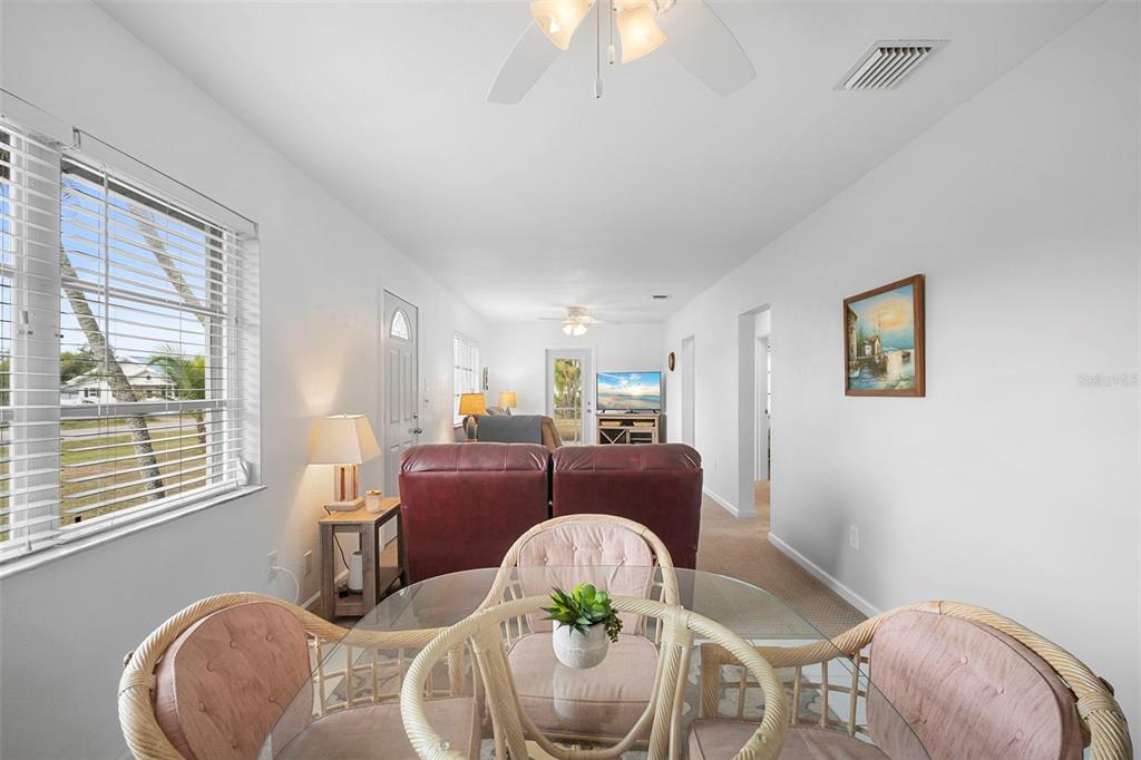 29098 Riverview Lane Punta Gorda, FL 33982 - Photo 9 of 35 a dining room with furniture a window and wooden floor