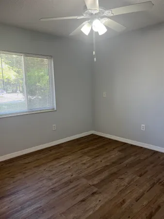an empty room with window and closet