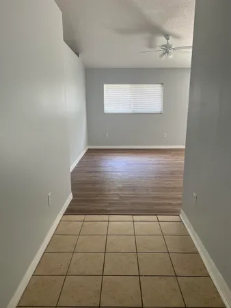 an empty room with wooden floor and closet