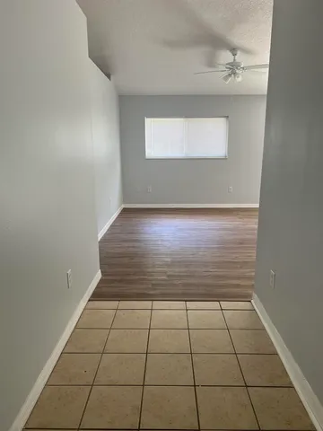 an empty room with wooden floor and closet