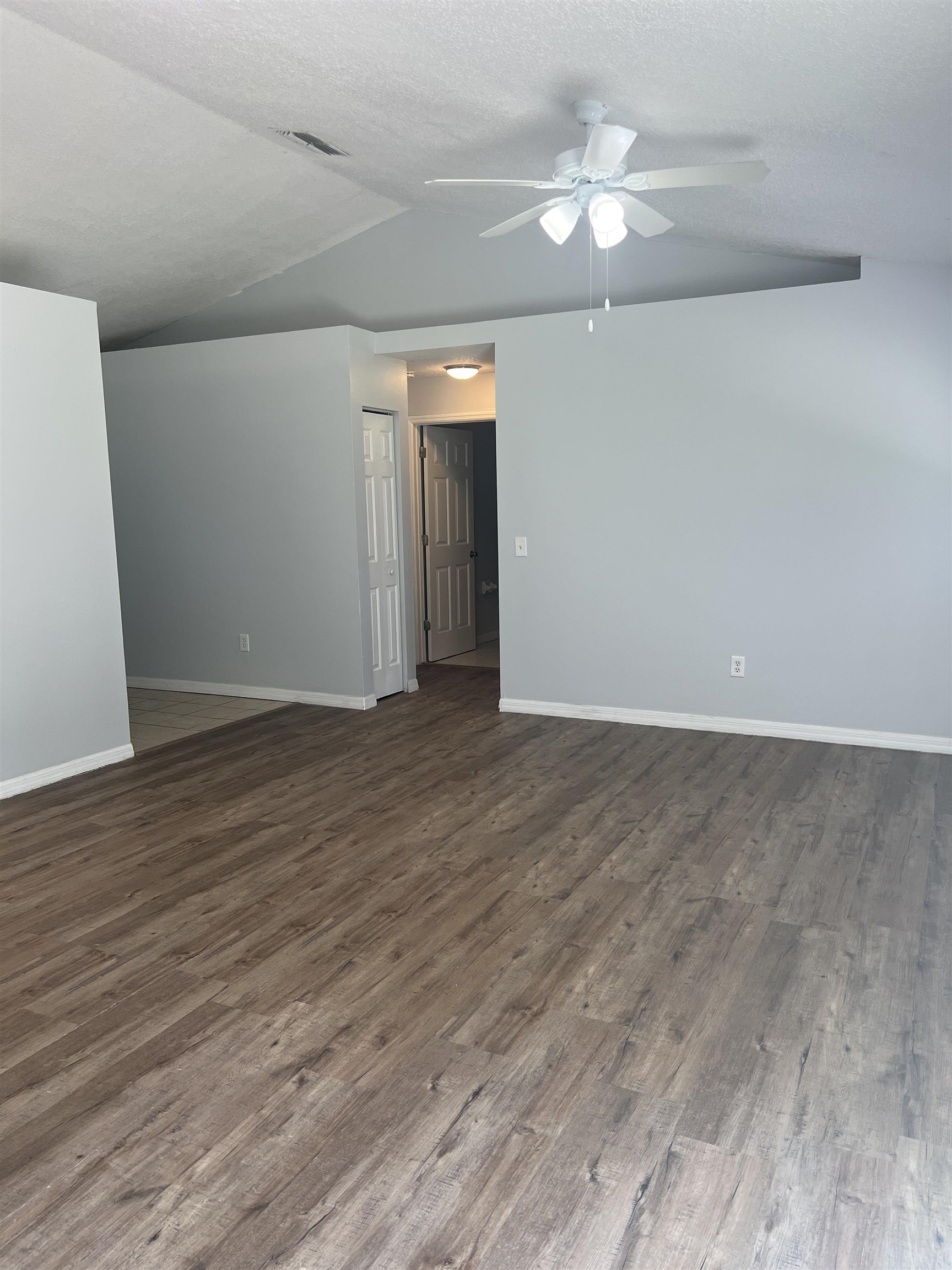 5465 Datil Pepper Road St. Augustine, FL 32086 - Photo 5 of 28 a view of an empty room with wooden floor and a ceiling fan