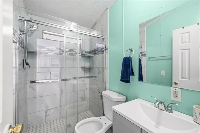 a bathroom with a sink toilet and shower