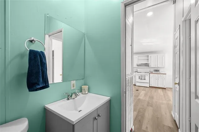 a bathroom with a sink a toilet and a mirror