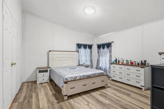 a bedroom with a bed and a dresser