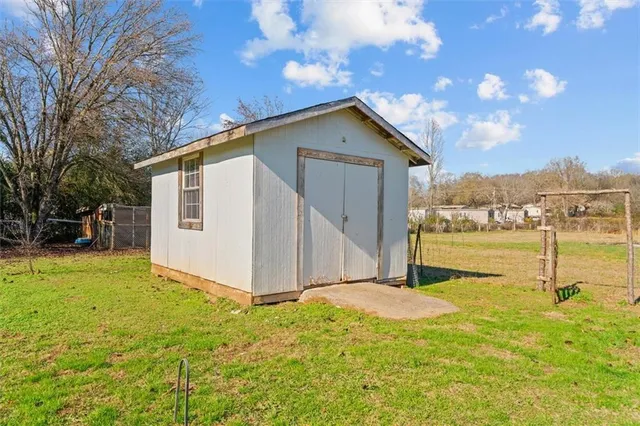 a view of backyard of house with green space
