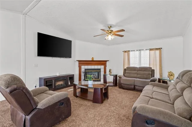 a living room with furniture a fireplace and a flat screen tv