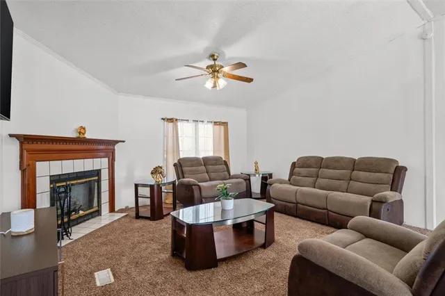 a living room with furniture and a fireplace