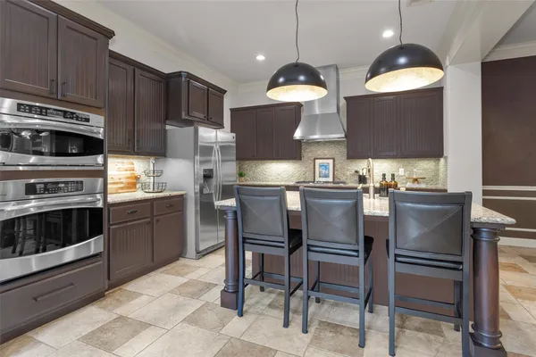 a kitchen with a sink stainless steel appliances and cabinets