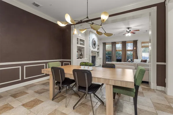 a view of a dining room with furniture and a chandelier