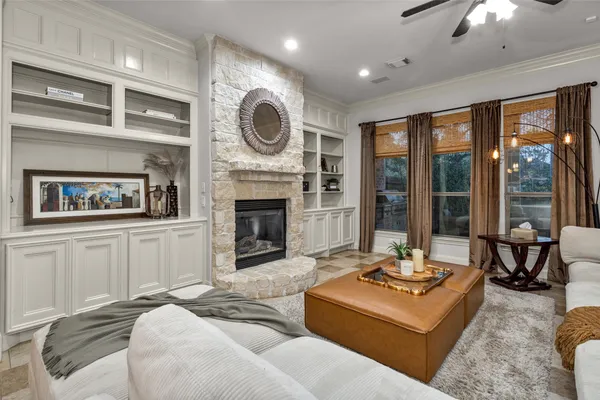 a living room with fireplace furniture and a large window