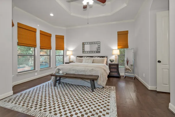 a bedroom with a bed and a lamp next to a window
