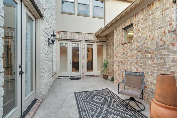 a view of a porch with chairs and front door