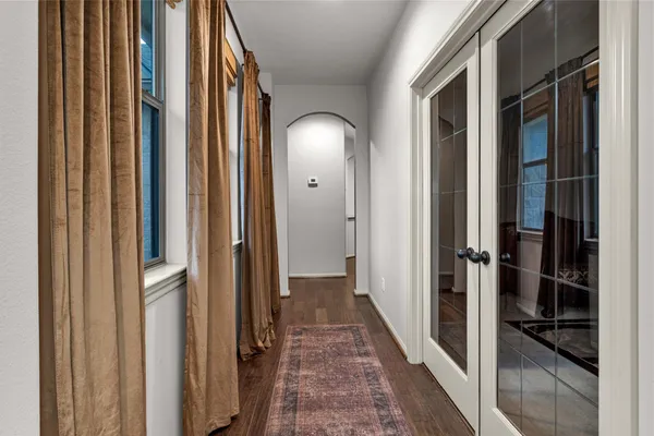 a view of a hallway with wooden floor and staircase