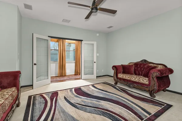 a spacious bedroom with a bed and window