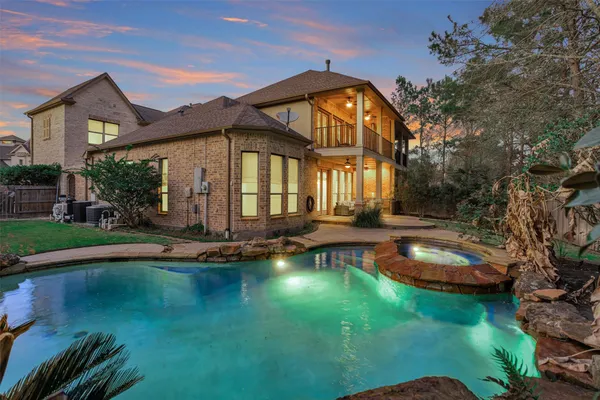 a view of a house with swimming pool and porch