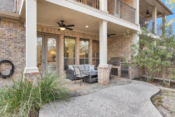 a building outdoor space with patio furniture and potted plants