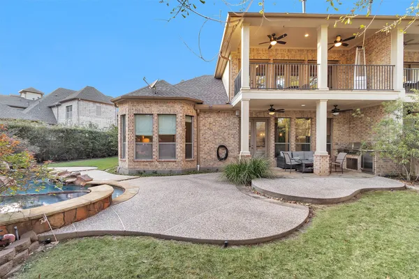 a view of a house with backyard and sitting area