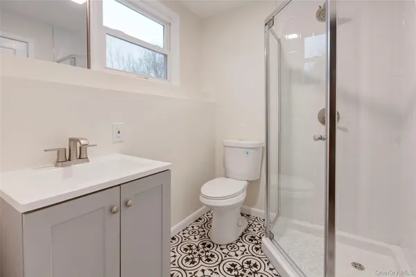 a bathroom with a sink toilet and a mirror