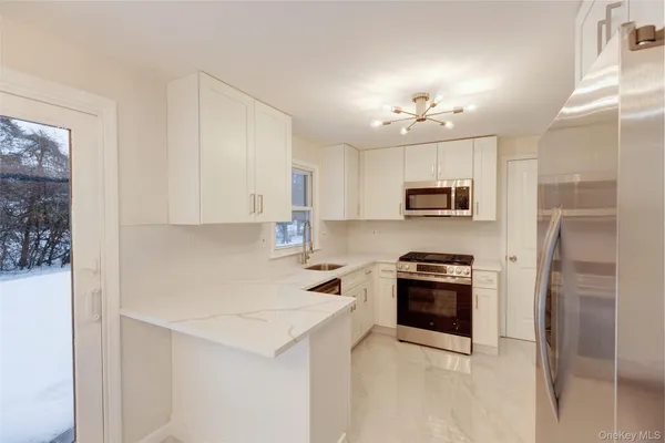 a kitchen with cabinets stainless steel appliances and a counter space
