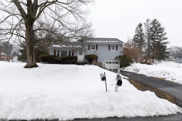 a view of a white house with a yard
