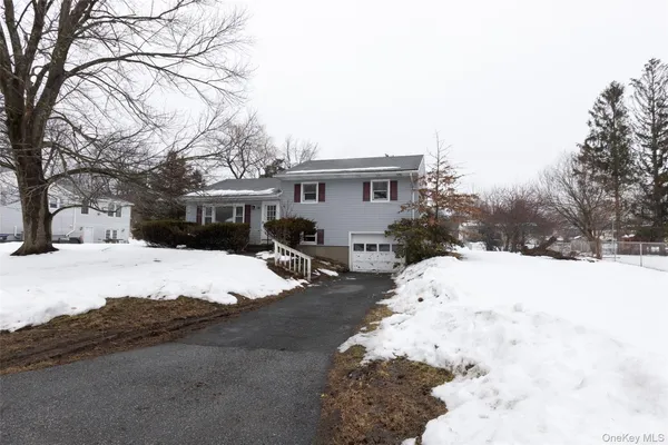 a view of a house with a snow in the yard