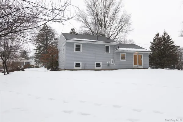 a view of house with a yard covered in snow