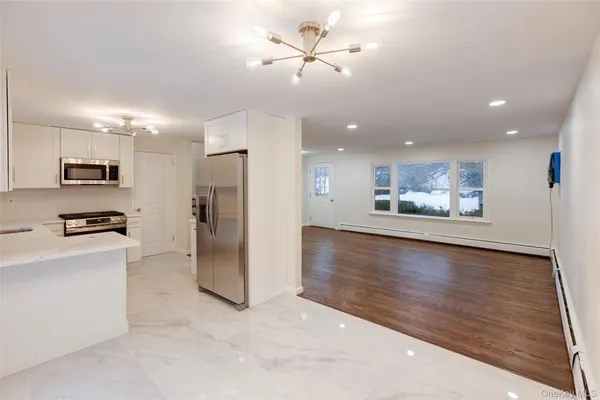 a view of a kitchen with a sink and a refrigerator