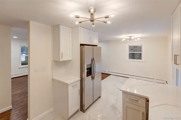 a kitchen with stainless steel appliances a refrigerator and cabinets