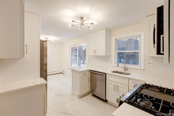 a kitchen that has a sink and a stove in it
