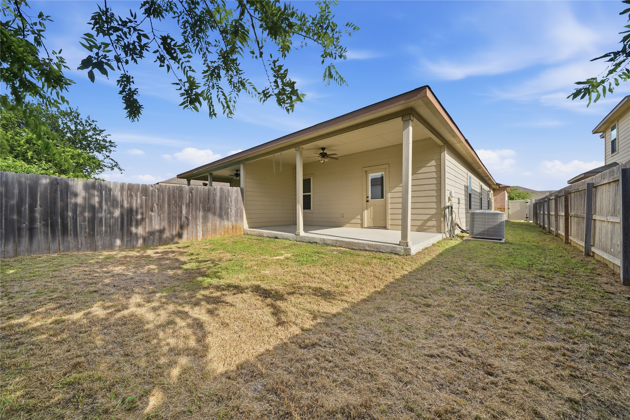 533 Jack Rabbit Lane, Unit A Buda, TX 78610 - Photo 31 of 34 Fenced backyard retreat offering a covered patio for outdoor enjoyment.