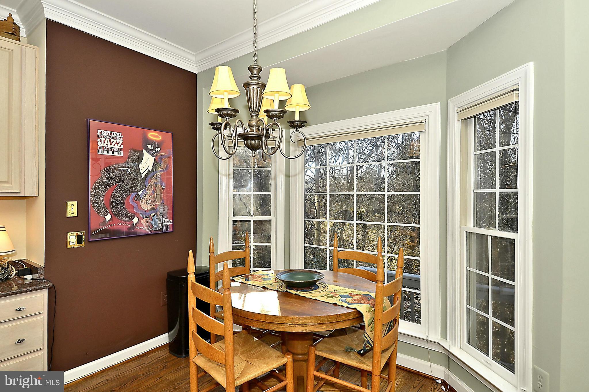 148 Rees Place Falls Church, VA 22046 - Photo 16 of 29 a view of a dining room with furniture a chandelier and wooden floor
