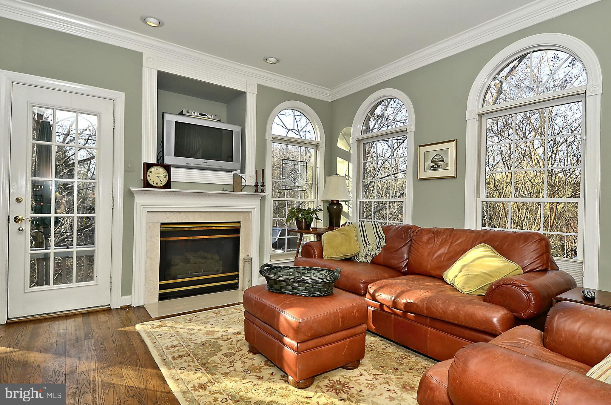 148 Rees Place Falls Church, VA 22046 - Photo 18 of 29 a living room with furniture a large window and a fireplace