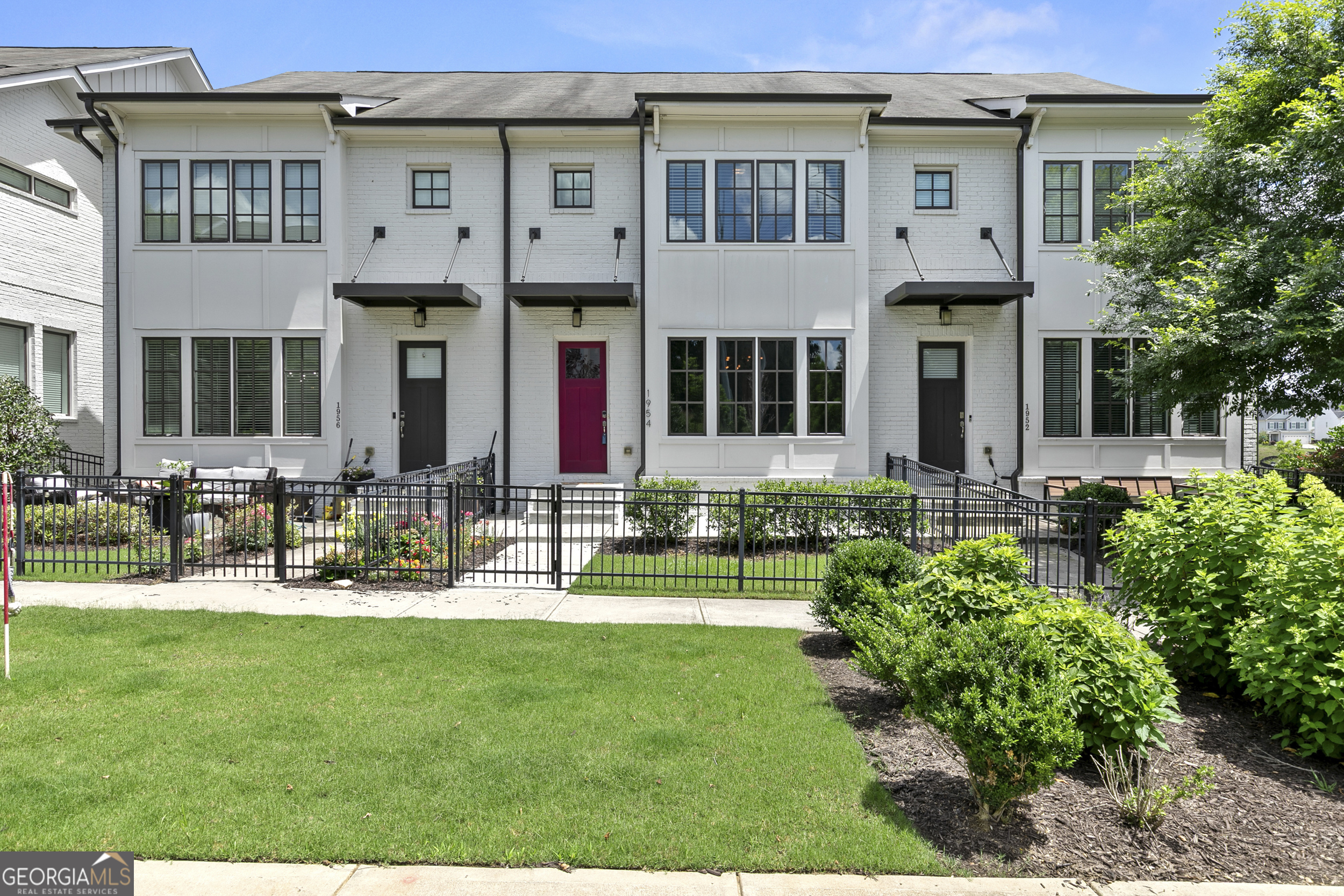 a front view of a house with a yard table and chairs