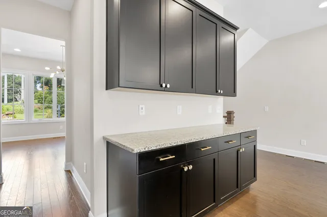 a kitchen with stainless steel appliances granite countertop a sink and a stove with wooden floor