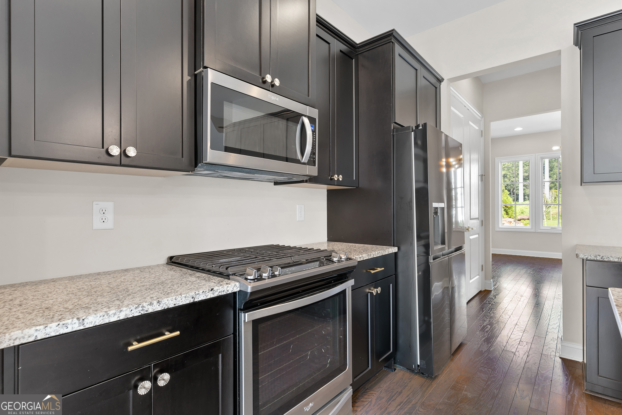 1954 Summit Trace Circle Northwest Atlanta, GA 30318 - Photo 14 of 45 a kitchen with stainless steel appliances granite countertop a stove microwave and refrigerator